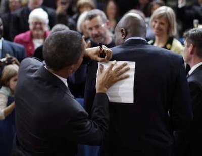 obama-signing-paper-on-back.jpg