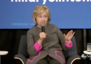 hillary-holding-hand-up
