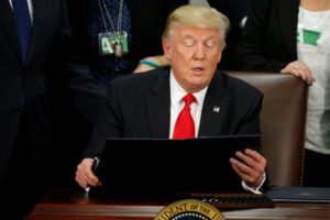 Trump signing the lunancy